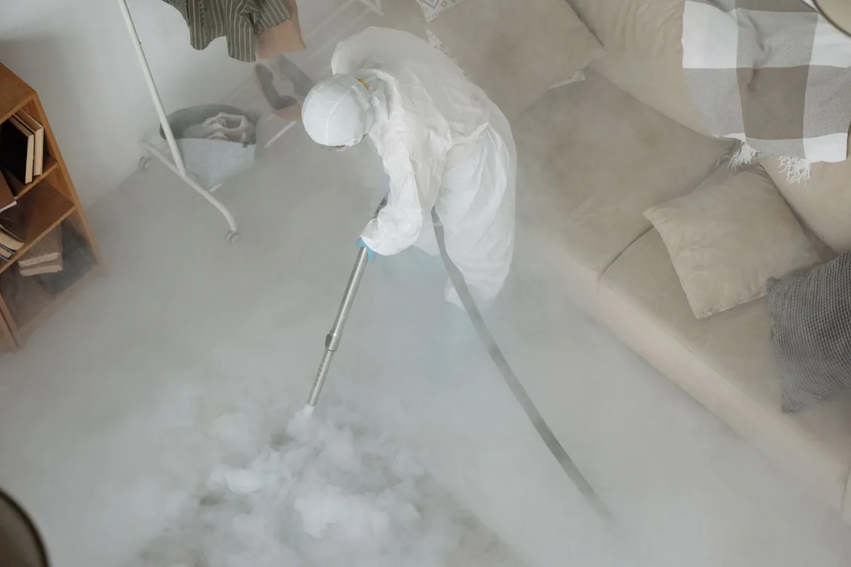 Biohazard cleanup technician in protective equipment, El Cenizo, TX
